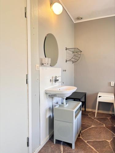 a bathroom with a sink and a mirror at B&B Villa Vila in Löttorp