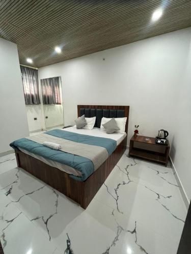 a bedroom with a bed in a room with a cracked floor at Hotel raj inn in Lucknow