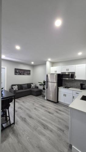 a kitchen and living room with a couch and refrigerator at Our Beautifull and comfortable place in Fort Myers