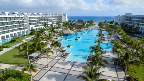 an aerial view of the resort with palm trees and the ocean at Ocean Eden Bay - Adults Only - All Inclusive in Falmouth