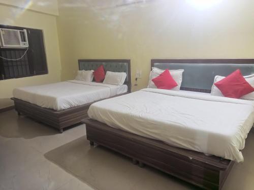 two beds in a room with two beds sidx sidx sidx at Hotel R Himalayan in Mohali