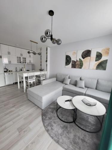 a living room with a couch and a table at Apartment 10 in Inđija