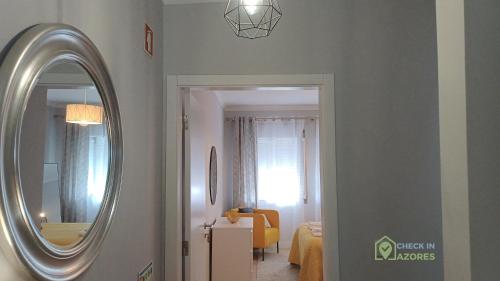 a hallway with a mirror and a room at Cantinho da Bea Guest House in Angra do Heroísmo