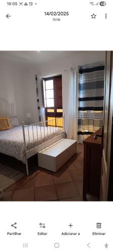 a bedroom with a bed and a window at Casa David Duplex in Olhão
