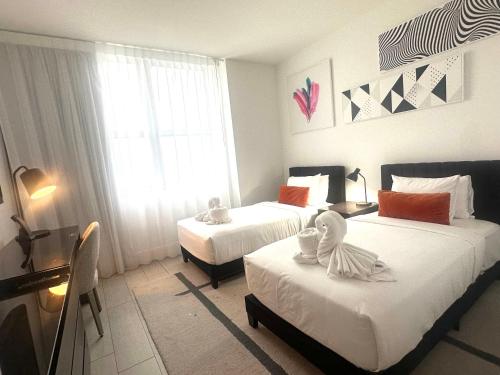 a hotel room with two beds and a window at Hide House in Hollywood