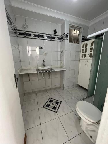 a white bathroom with a sink and a toilet at Av Paulista GF in São Paulo