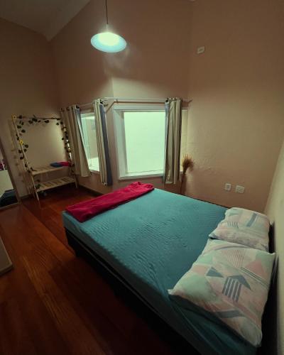 a bedroom with a large bed with a window at Av Paulista GF in São Paulo