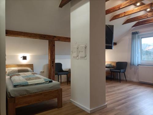 a bedroom with a bed and a table and chairs at Gästezimmer Kalletal in Kalletal