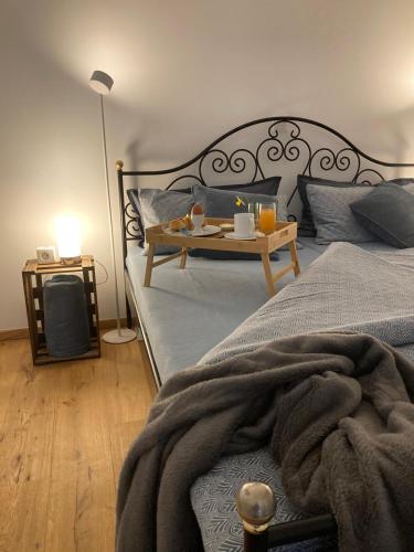 a bedroom with a bed and a table with food on it at Ferienwohnung Strandmuschel in Lembruch