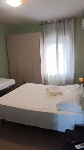 a large white bed in a room with a window at HOTEL Via Emilia Ovest 224 SELF CHECK-IN in Parma