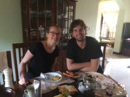 a man and woman sitting at a table with food at Grace Green Ville in Negombo