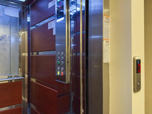 a metal elevator with a door in a room at Doga Motel in Uzungöl