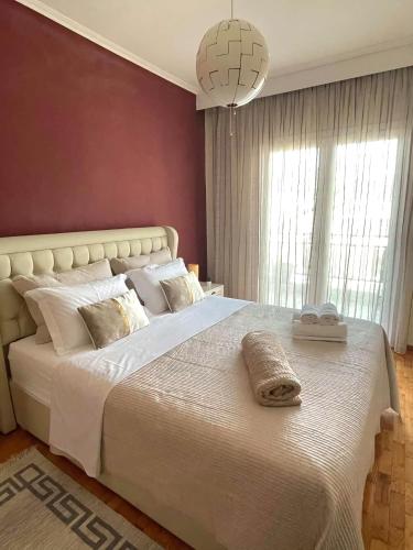 a bedroom with a large white bed with pillows on it at ANATOLI Waterfalls Retreat in Edessa