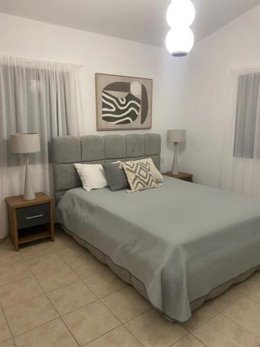 a bedroom with a large bed with pillows on it at Alkiviades Villa in Theletra