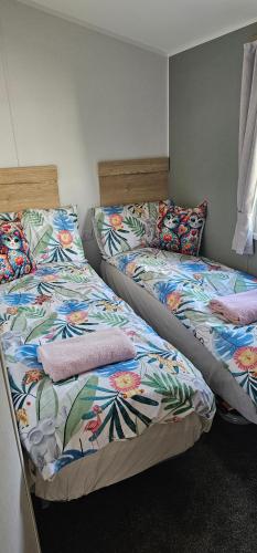 two beds sitting next to each other in a room at Sunny Haven in Skegness