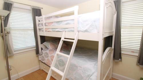 a white bunk bed in a room with windows at Broadway Beach Retreat Unit 4 in Cape May