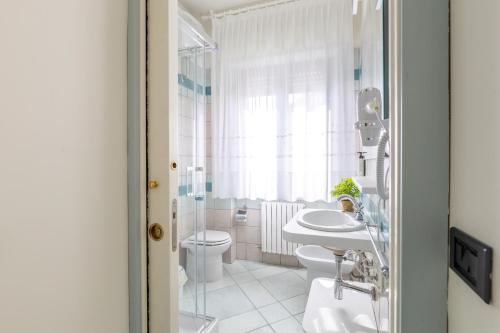 a bathroom with a toilet and a sink and a shower at Affittacamere 2 Prima Fila Mare in Porto Recanati