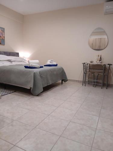 a bedroom with a bed and a tiled floor at Ioana Sea View in Corfu