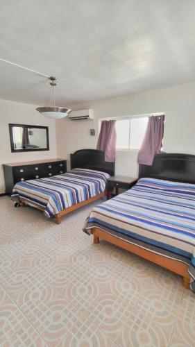 a hotel room with two beds in a room at Hotel Catalina in Torreón