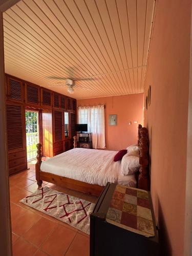 a bedroom with a bed and a table in it at Pascall's Luxury Homes Villa in Lambeau