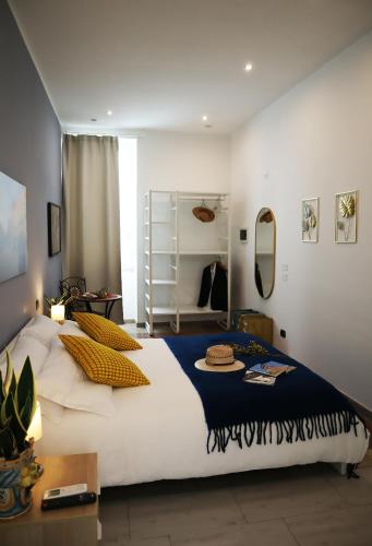 a bedroom with a large white bed with pillows on it at Fortuna Guest House - Charm & Relax rooms in Syracuse