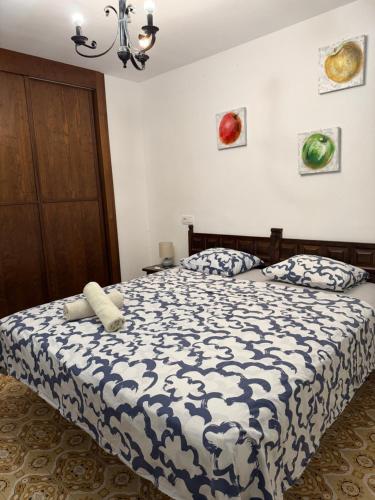 a bedroom with a bed with a black and white comforter at Miami-Playa in Miami Platja