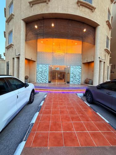 two cars parked in front of a building at صفاء المسكن in Dammam