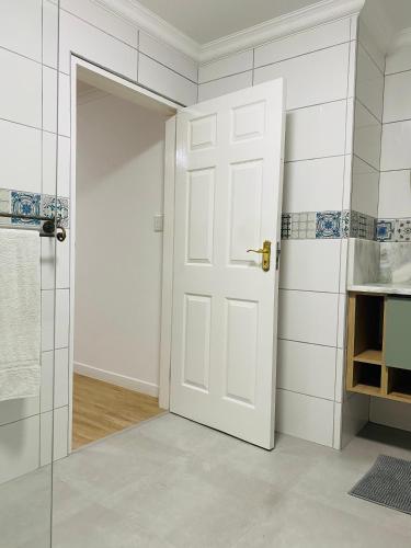 a bathroom with a white door and a shower at Lagoon Staycation in Walvis Bay