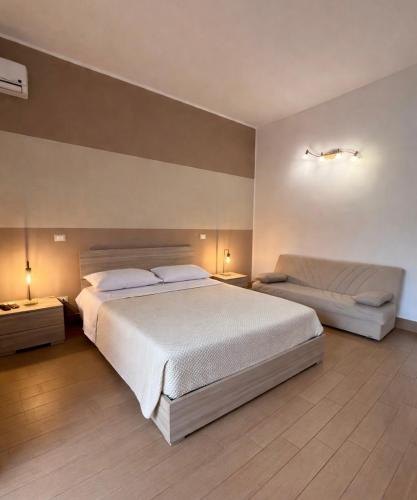 a bedroom with a large bed and two night stands at Case Vacanze nonna Elisa in Avola