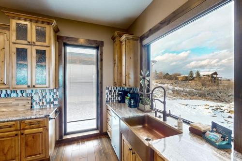 a kitchen with a sink and a large window at Raspberry Ridge Lodge in Fish Haven