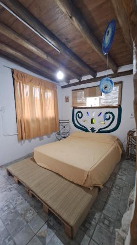 a bedroom with a large bed in a room at Biocasa in Villa Anizacate