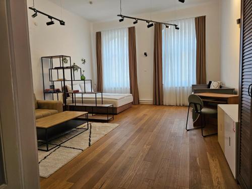 a living room with a couch and a table at ELEVEN APARTMENT - Very Center - Free Parking in Osijek