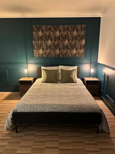 a bedroom with a large bed with two tables at Escapade Chic in Renwez