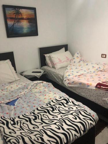 a room with two beds in a room at Bar Restaurant Hotel Drraska in Maliq