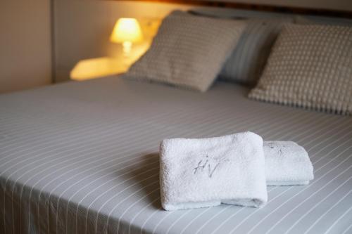 a bed with two towels on top of it at Holiday Vibes in Pisa