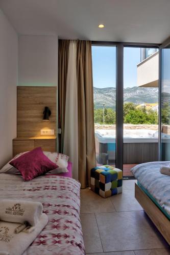 a bedroom with a bed and a window with a view at Villa Radman in Korčula