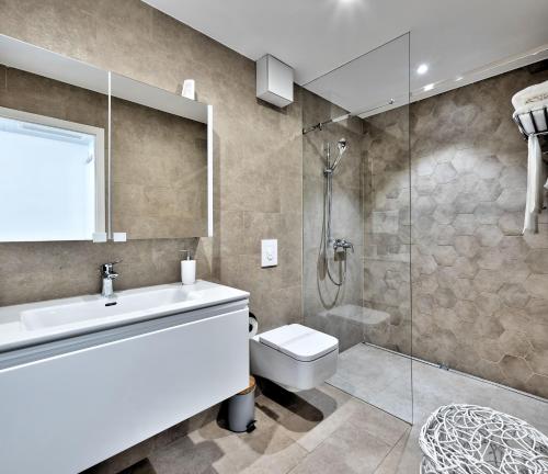 a bathroom with a shower and a toilet and a sink at Villa Radman in Korčula