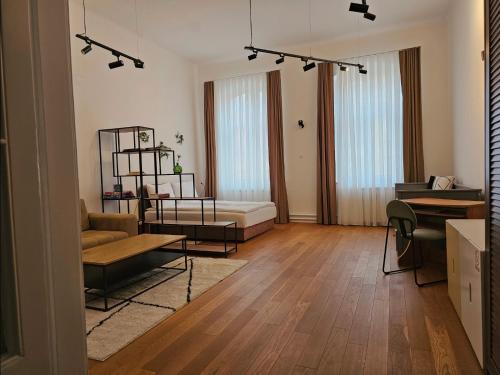 a living room with a couch and a table at ELEVEN APARTMENT - Very Center - Free Parking in Osijek