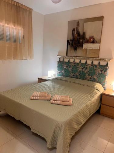 a bedroom with a bed with two towels on it at Valdés in Callao Salvaje