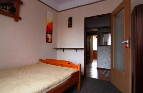 a bedroom with a bed and a open door at mieszkanie Akacjowa in Stronie Śląskie
