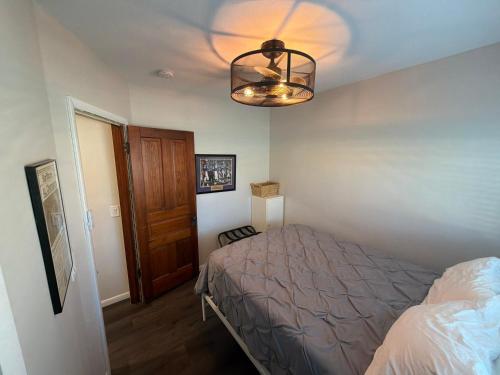a bedroom with a bed and a chandelier at Albert Lea revival in Albert Lea
