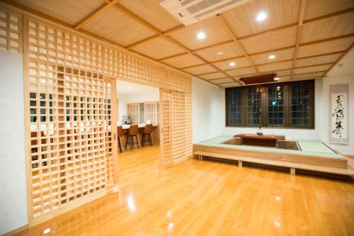 a living room with a large room with wooden floors at Matsuya hotel in Myoko