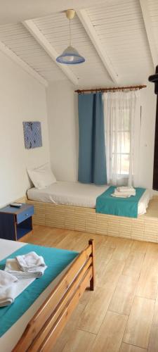 a bedroom with two beds in a room at Bambola Apartments in Nea Moudania