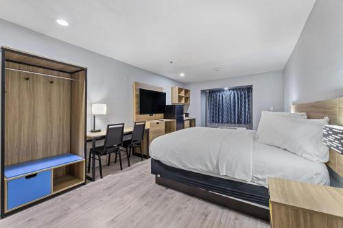 a hotel room with a bed and a desk at Day Inn by Wyndham San Antonio Downtown in San Antonio