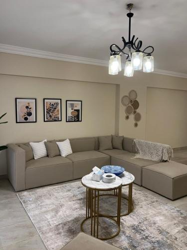 a living room with a couch and a table at Quiet Comfy Stay in Burg el-Ḥudûd