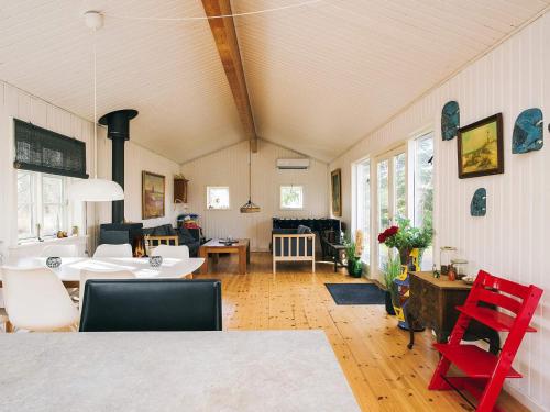 a living room with a table and red chairs at 6 person holiday home in Grevinge-By Traum in Grevinge