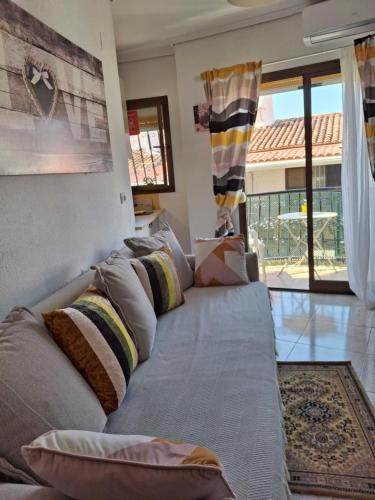 a couch with pillows on it in a living room at Apartamento Retiro in Denia