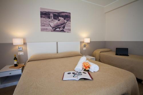 a hotel room with a bed with a tray with scissors at Hotel Costazzurra Museum & Spa in San Leone
