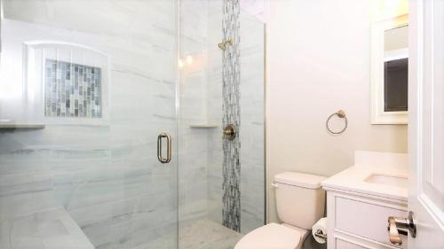 a bathroom with a shower with a toilet and a sink at Bay Breeze in Town Bank
