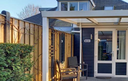 a house with a patio with a door and a fence at Oud Kempen Bungalow 183 in Stavenisse